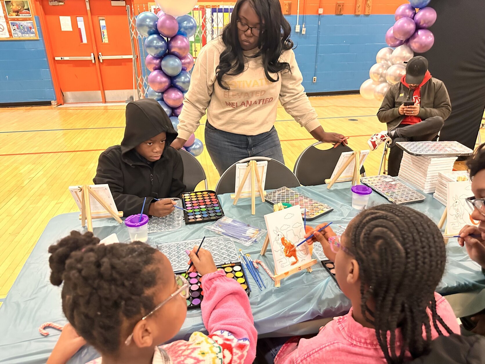 Kids painting during the Toy Giveaway event.