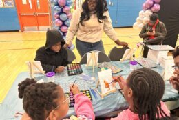 Kids painting during the Toy Giveaway event.