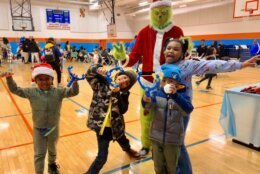 Kids posing with the Grinch during the Toy Giveaway event.