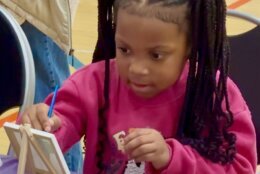 Child painting at toy giveaway event