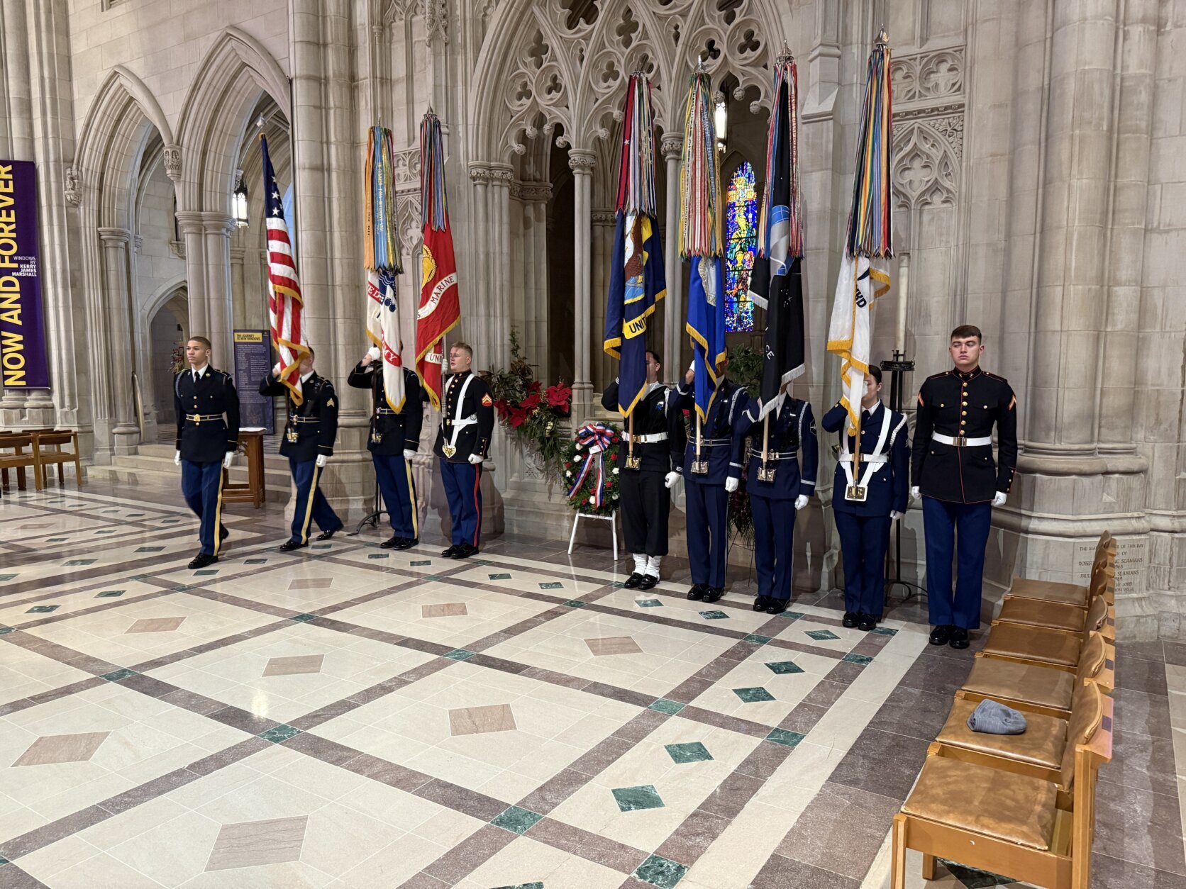 military members standing near wreath