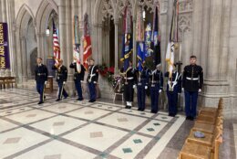 military members standing near wreath