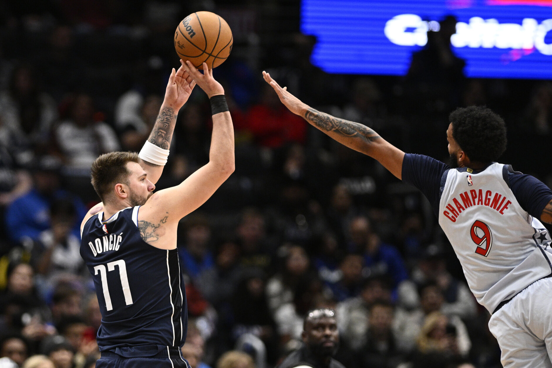 Dallas Mavericks guard Luka Doncic (77) looks to shoot against Washington Wizards forward Justin Champagnie (9) during the first half of an NBA basketball game, Thursday, Dec. 5, 2024, in Washington. (AP Photo/Nick Wass)