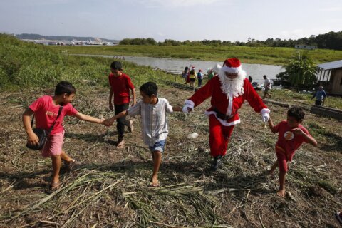 Santa braves the sticky heat of the Amazon jungle to bring gifts to children in Brazilian village