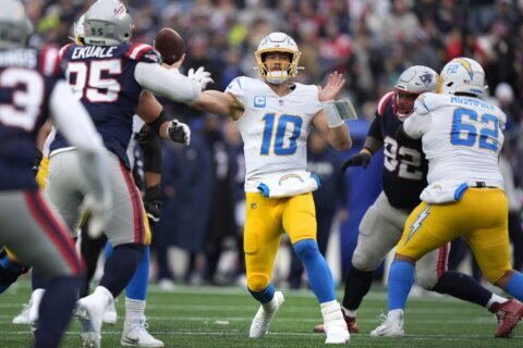 Herbert tosses 3 TD passes and Chargers secure a playoff spot with a 40-7 rout of Patriots