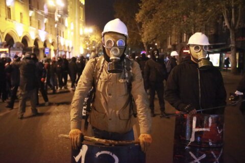 Police in Georgia arrest an opposition leader as mass protests continue