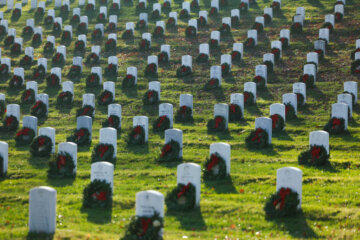 Christmas wreaths on headstones at Arlington National Cemetery