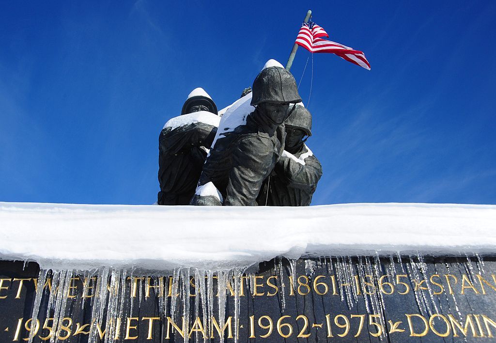 Snow covers the Marine Corps War Memorial in Arlington, Virginia on December 20, 2009. The Washington, DC  area was hammered December 19 by a fierce snowstorm that dumped more than a foot (38.48cm) of snow. AFP PHOTO/Karen BLEIER        (Photo credit should read KAREN BLEIER/AFP via Getty Images)