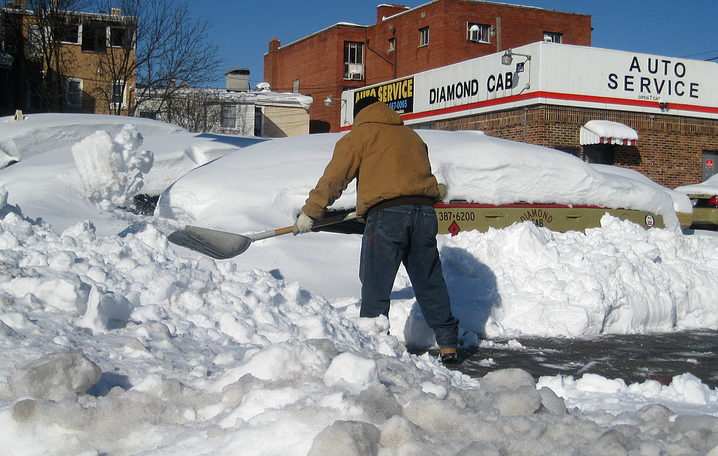 A man shovels snow at a cab  hub in North West Washington, DC on February 11, 2010. A blizzard on February 10, 2010 turned the 2009-2010 winter into the snowiest ever on record for the Washington area with millions trapped at home, many without power, and the federal government shut down for the fourth day in a row. Washington's public transportation system was still only providing limited service with only a few bus routes operating.  AFP PHOTO  Eva HAMBACH (Photo credit should read EVA HAMBACH/AFP via Getty Images)