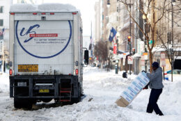 WASHINGTON - FEBRUARY 11:  A man delivers restaurant supplies on an unplowed street following yesterday�s snowstorm February 11, 2010 in Washington, DC. Washingtonians had to dig out again after the region was hard hit by a second mega snowstorm in five days making 2009 - 2010 the snowiest winter since the record has been kept in 1870.  (Photo by Alex Wong/Getty Images)