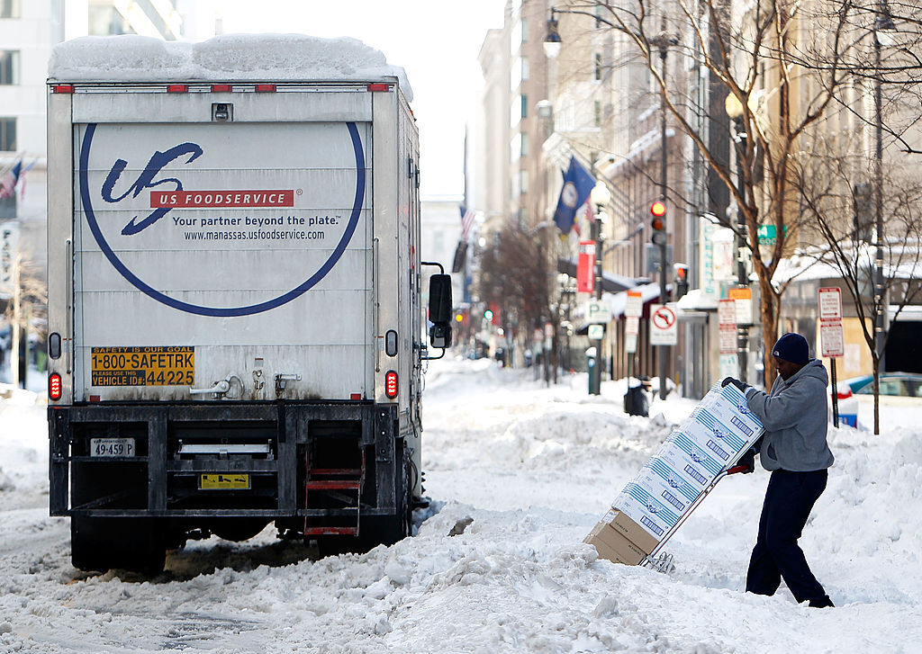 WASHINGTON - FEBRUARY 11:  A man delivers restaurant supplies on an unplowed street following yesterday�s snowstorm February 11, 2010 in Washington, DC. Washingtonians had to dig out again after the region was hard hit by a second mega snowstorm in five days making 2009 - 2010 the snowiest winter since the record has been kept in 1870.  (Photo by Alex Wong/Getty Images)