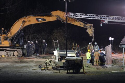 Rescuers reassess the safety of their search for a woman they believe fell into a sinkhole