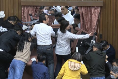 Taiwan lawmakers clash after party members break into legislature to occupy speaker’s chair