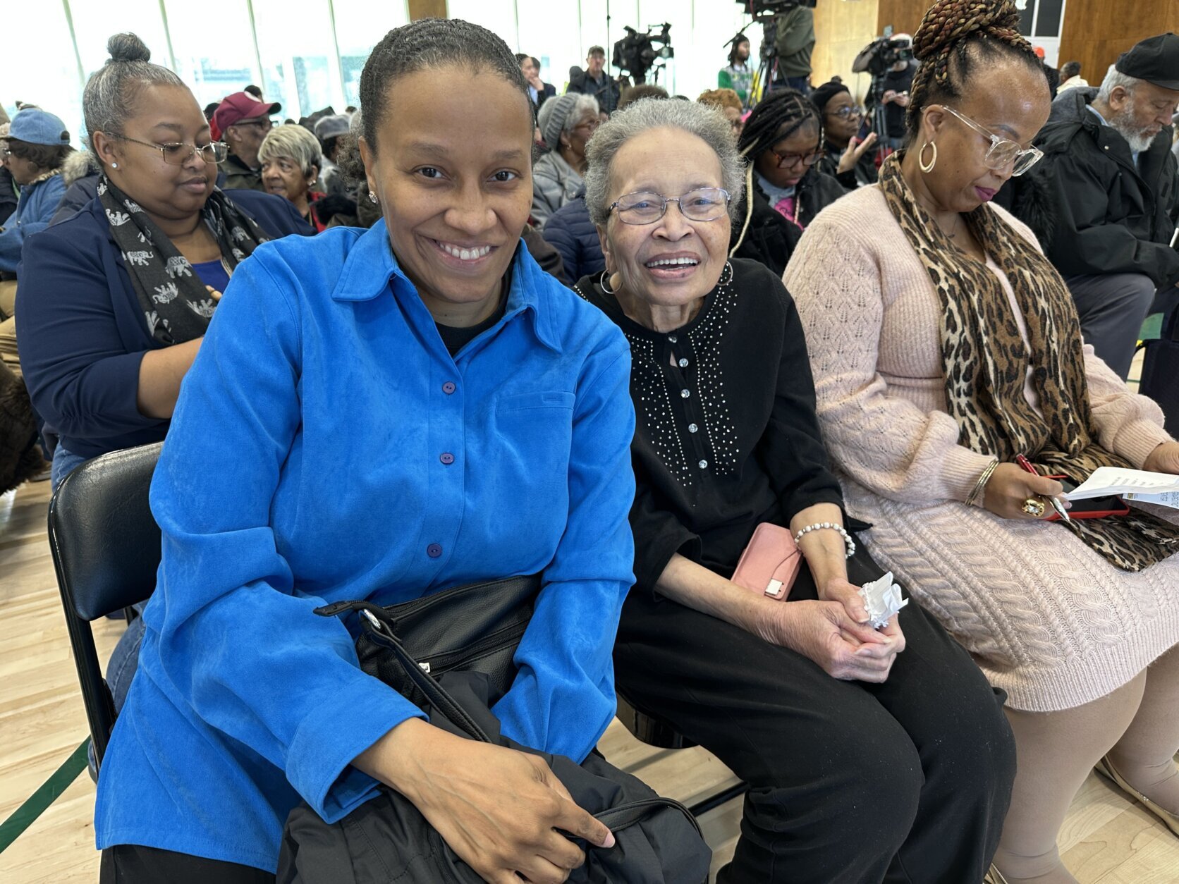 two women sit next to each other for photo