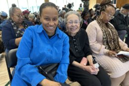 two women sit next to each other for photo