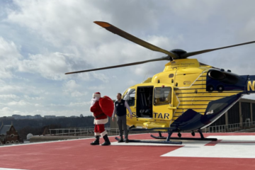 santa getting out of a yellow helicopter