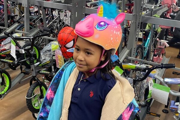 girl wearing unicorn bike helmet