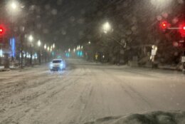 Snowy street with oncoming car