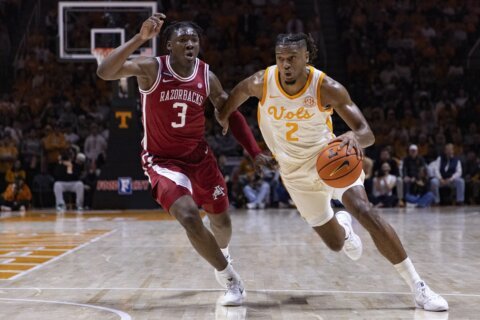 No. 1 Tennessee beats No. 23 Arkansas 76-52 to match best start in program history