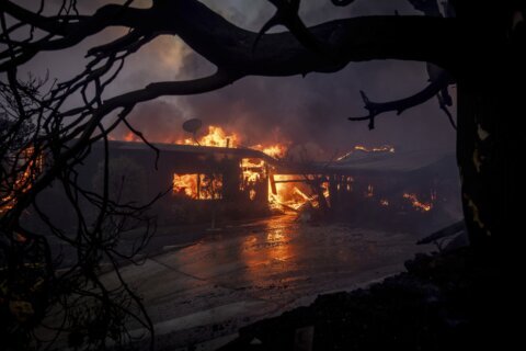 Wildfire burns through LA enclave known for its beaches and celebrity allure