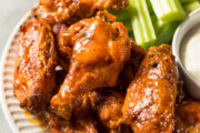 wings on a plate with a little celery in view