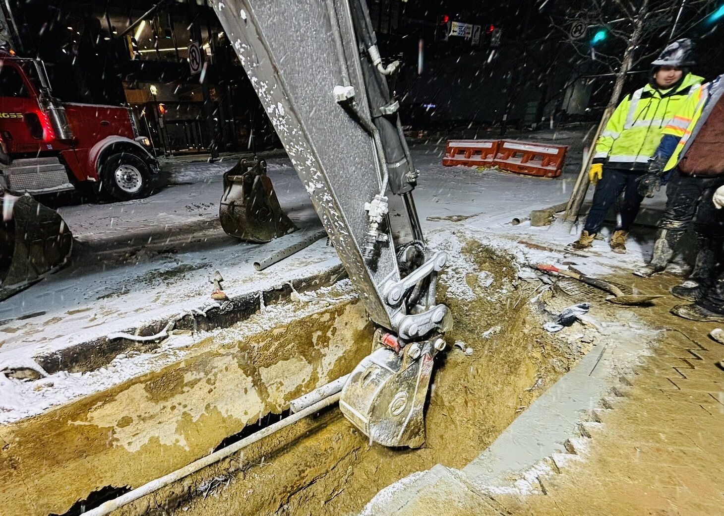 Crews excavate water main.