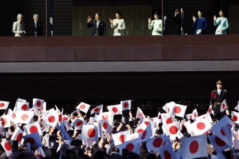 Japanese emperor and his family greet flag-waving crowd at the palace for New Year’s