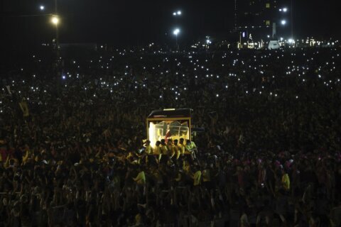 Filipino Catholics pray for good health and peace in huge procession venerating Jesus statue