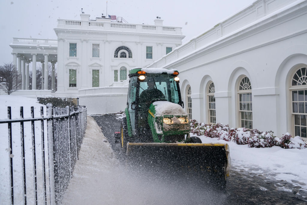 Workers clear snow from paths near the White House on January 6, 2025 in D.C.