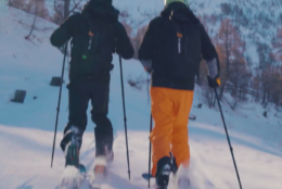 People going uphill on snowy slopes