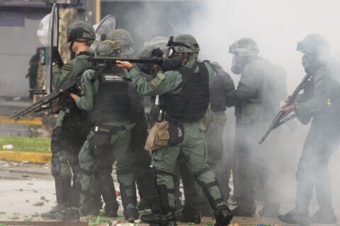 Argentine retirees and soccer fans clash with police during protests against austerity measures