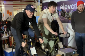 two men ride stationary bikes