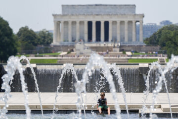 A boy cools off at the World War II Memorial, Tuesday, June 24, 2025, in Washington. (AP Photo/Julia Demaree Nikhinson)