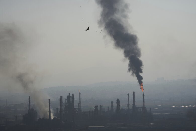 Smoke billows after an Iranian missile struck an oil refinery in Haifa