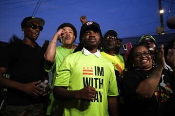 Trayon White stands surrounded by supporters.