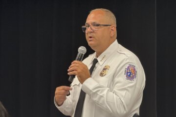 a police chief speaks into a microphone