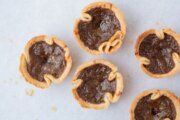 Butter tarts feature a flaky pastry shell and a buttery, sweet filling.