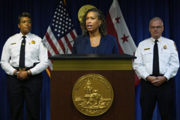 Washington Mayor Muriel Bowser speaks as Metropolitan Police Department Chief Pamela Smith, left, and D.C. Fire and EMS Chief John Donnelly, listen during a news conference on President Donald Trump's plan to place Washington police under federal control and deploy National guard troops to Washington, Monday, Aug. 11, 2025, in Washington. (AP Photo/Julia Demaree Nikhinson)