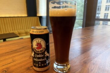 a glass and a can of beer