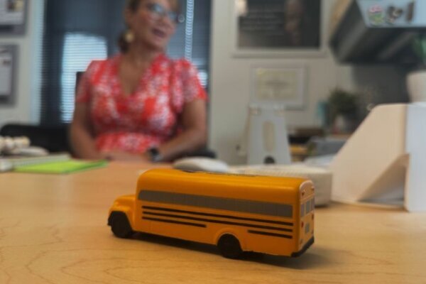 a figurine of a school bus sits on a desk