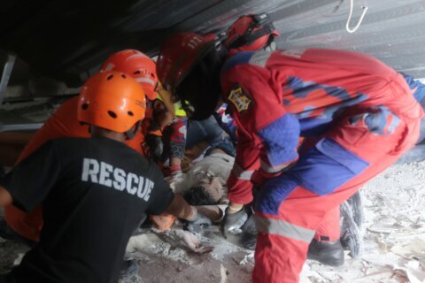 Rescuers run oxygen to survivors in Indonesia school building collapse that buried dozens