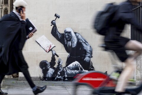 Banksy mural of a judge beating a protester is scrubbed from London court