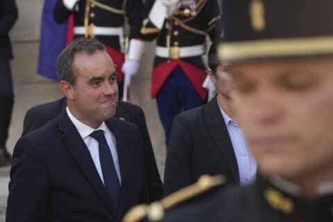 Strikes and protests roil France, pitting the streets against Macron and his new prime minister