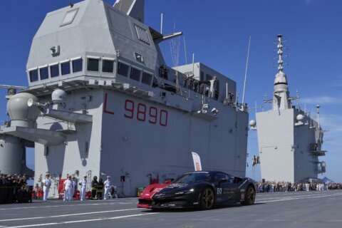 One man in an Italian supercar atop an aircraft carrier has a record in his sights