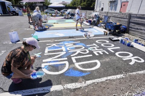 Parking spots used as colorful protest against Florida crackdown on rainbow crosswalks