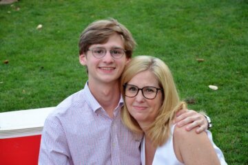 mother and son pose for photo