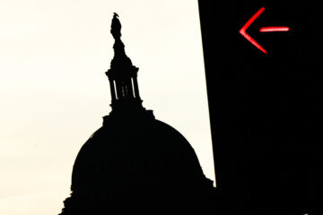 The U.S. Capitol dome and a traffic turn signal are seen from Pennsylvania Avenue, Wednesday, Oct. 1, 2025, in Washington.