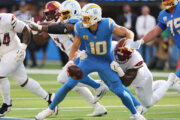 Los Angeles Chargers quarterback Justin Herbert (10) is sacked by Washington Commanders defensive end Dorance Armstrong during the second half of an NFL football game Sunday, Oct. 5, 2025, in Inglewood, Calif. (AP Photo/Eric Thayer)