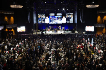 crowded room facing a stage