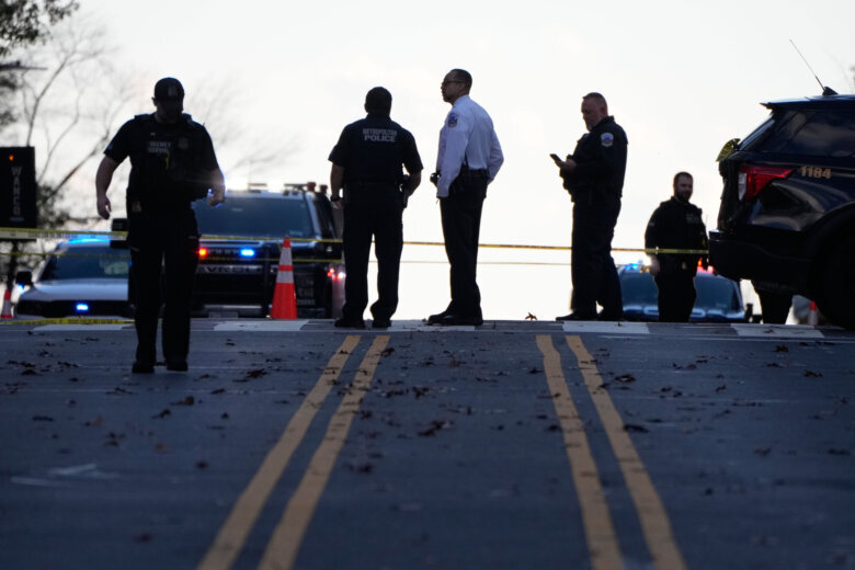 police investigating a shooting standing in the street